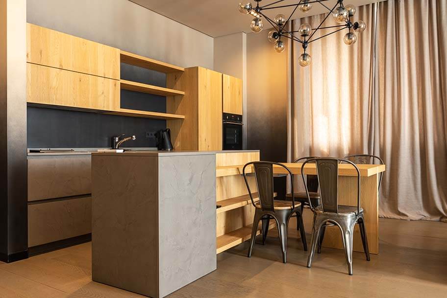 A kitchen with a bar and chairs