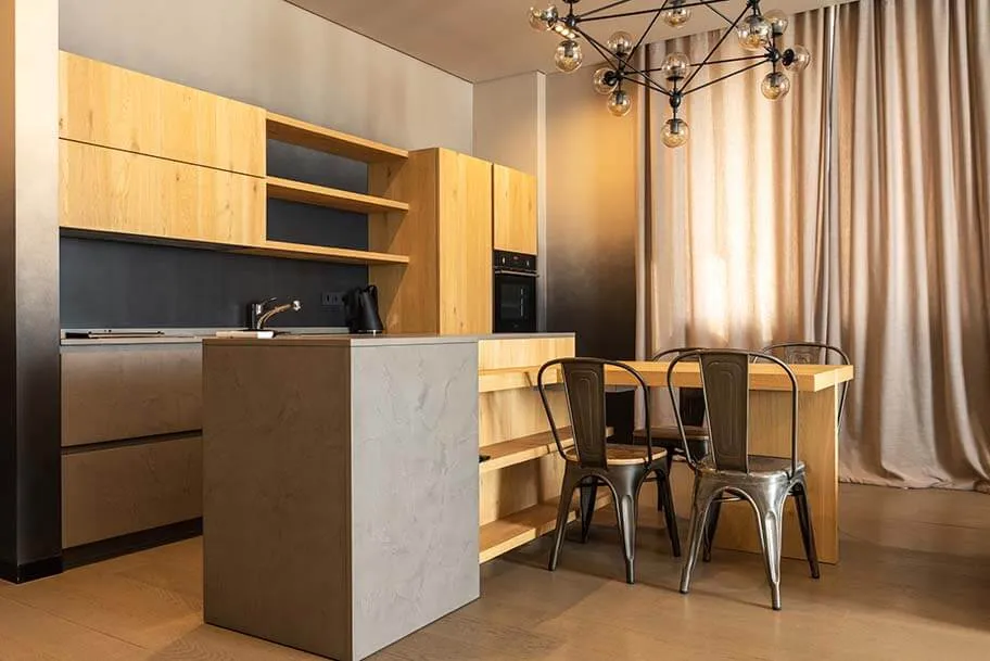 A kitchen with a bar and chairs