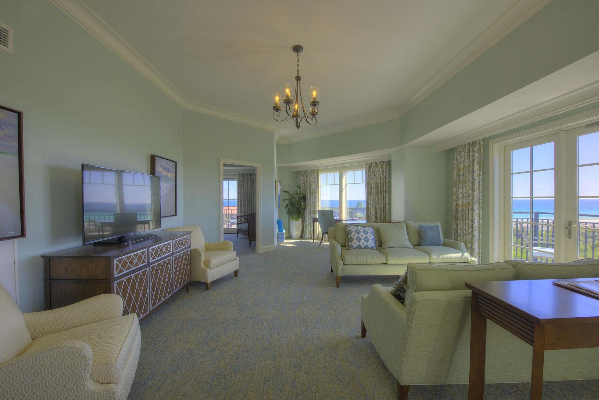 A penthouse suite with 180º views of the Gulf of Mexico, Henderson State Park, and tropical pools at The Henderson Beach Resort