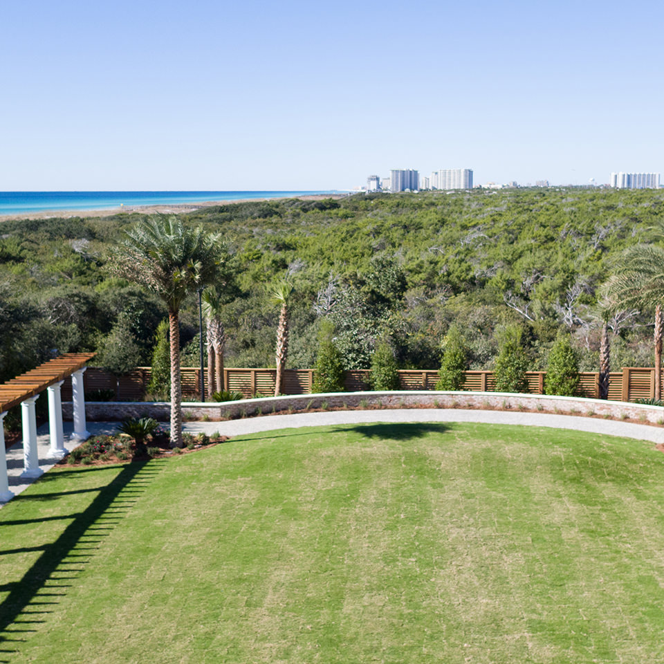The grand lawn, a lush green lawn with walking paths next to a pristine nature preserve