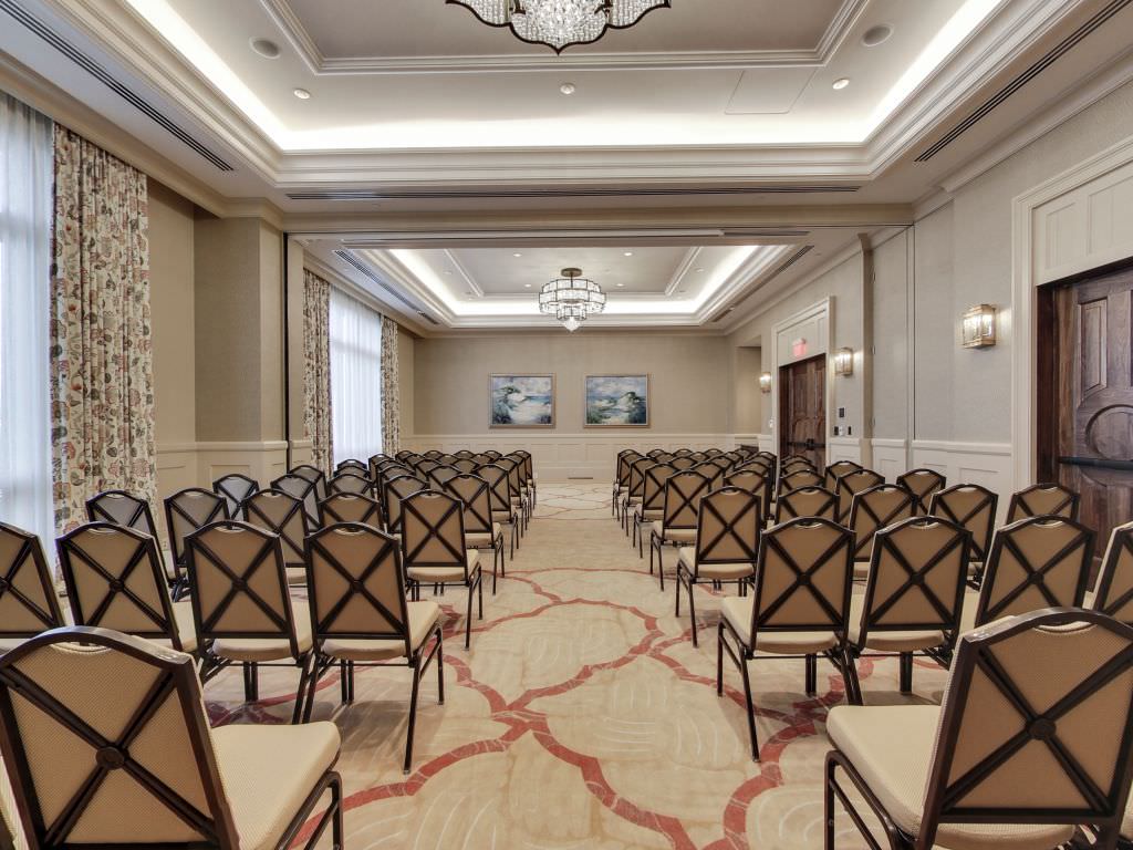 An arrangement of chairs for guests in the Destin Ballroom at The Henderson Beach Resort
