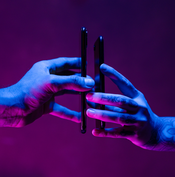 Two hands holding mobile phones