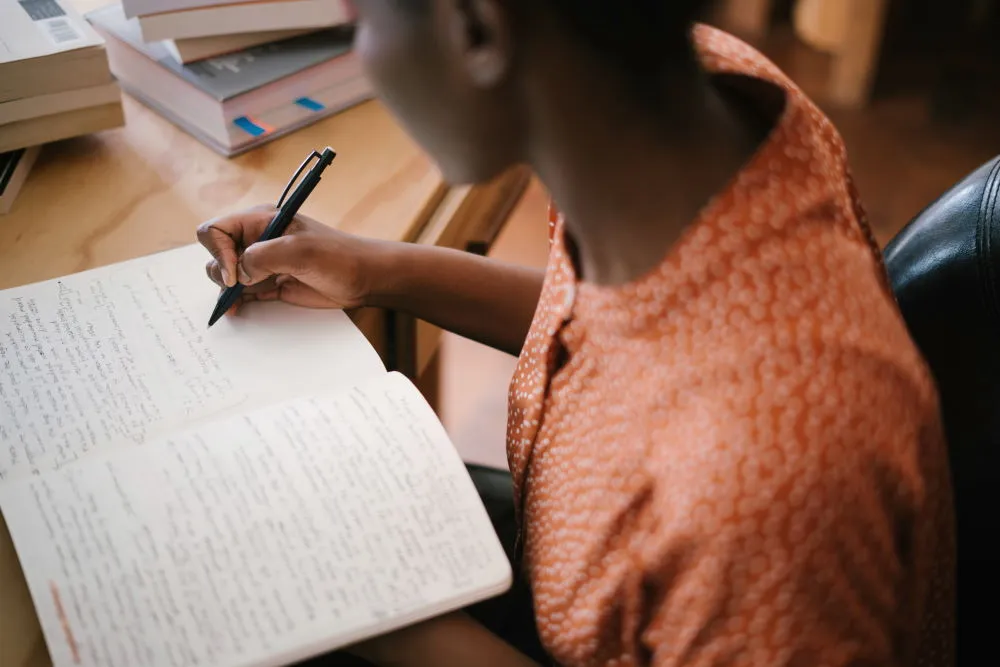 A woman studying the Bible and taking notes