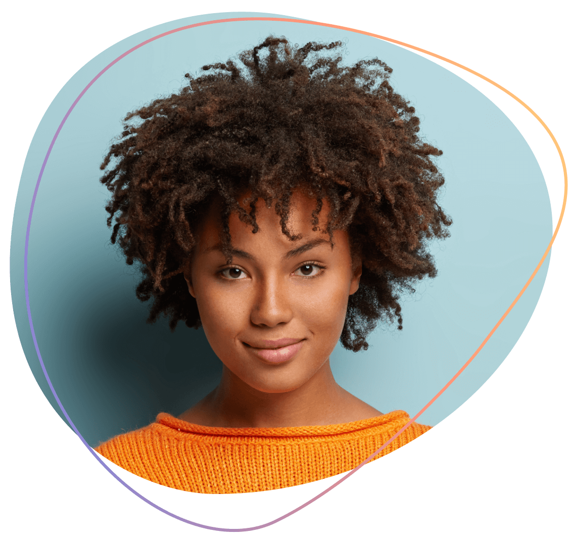 A woman in an orange jumper, smiling at the camera