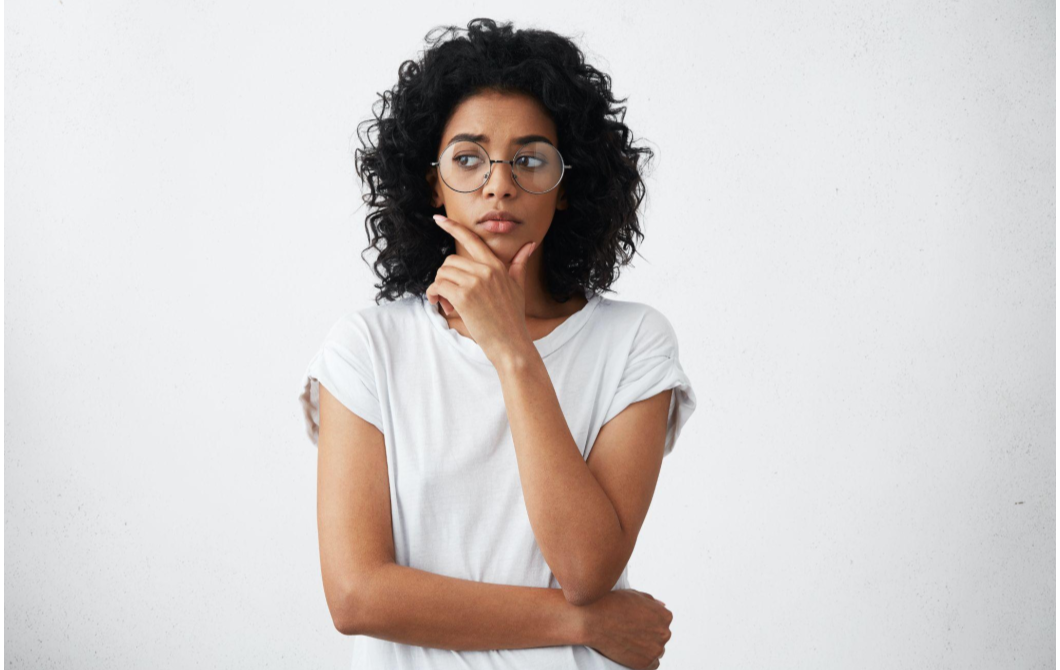 A woman looks off to the side, wondering if her sadness is actually depression