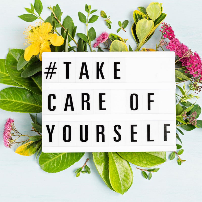 The words "Take Care of Yourself" on a mini marquee