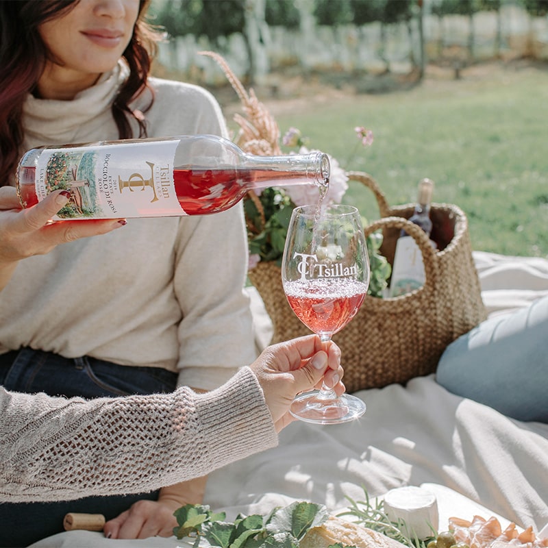 women having a picnic and pouring a glass of Tsillan Cellars wine