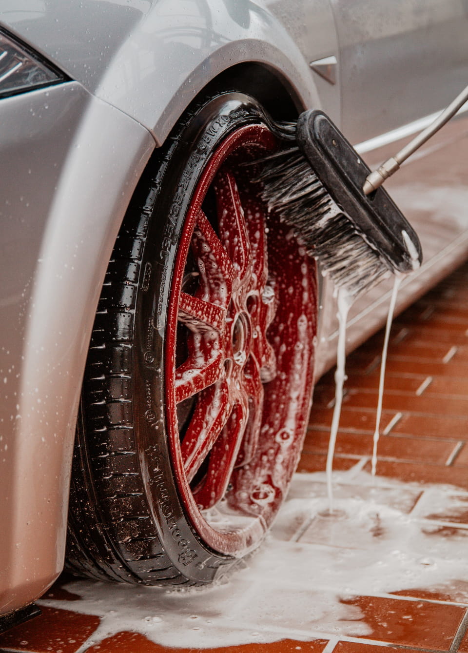 Red car rim gets washed