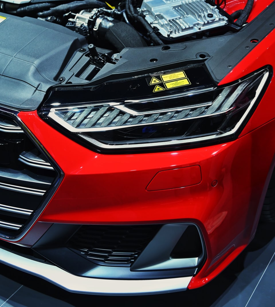 Red car with opened engine hood.
