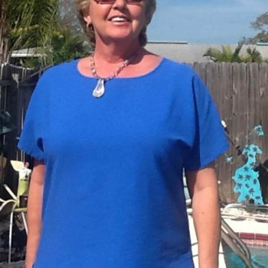 Woman wearing Cottonseed blue blouse.