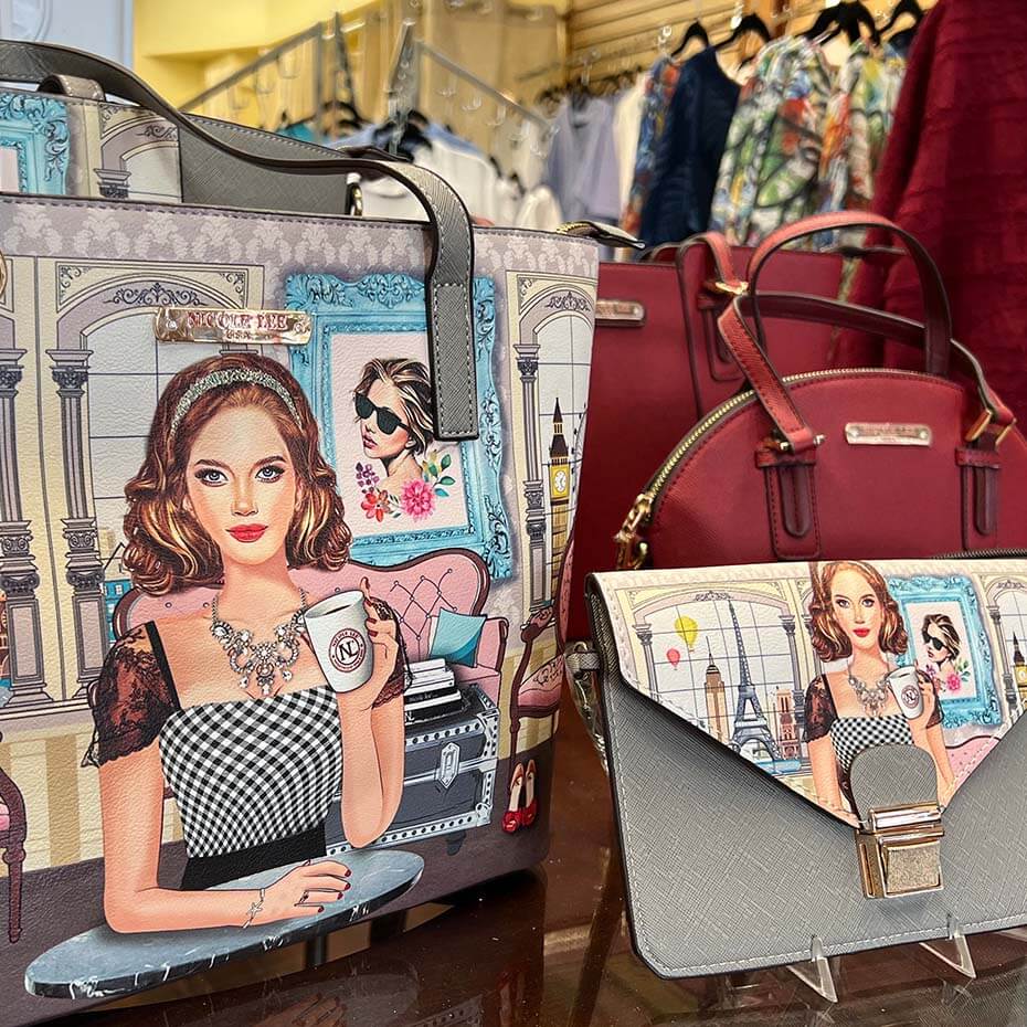 Nicole Lee graphic clutch and matching purse on Magda and Malena's Boutique front table.