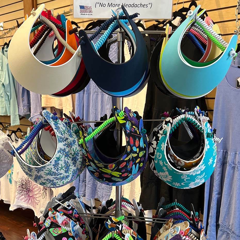 Magda and Malena's Boutique exclusive sunvisors from Incredible Sunvisor hanging on rack in store.