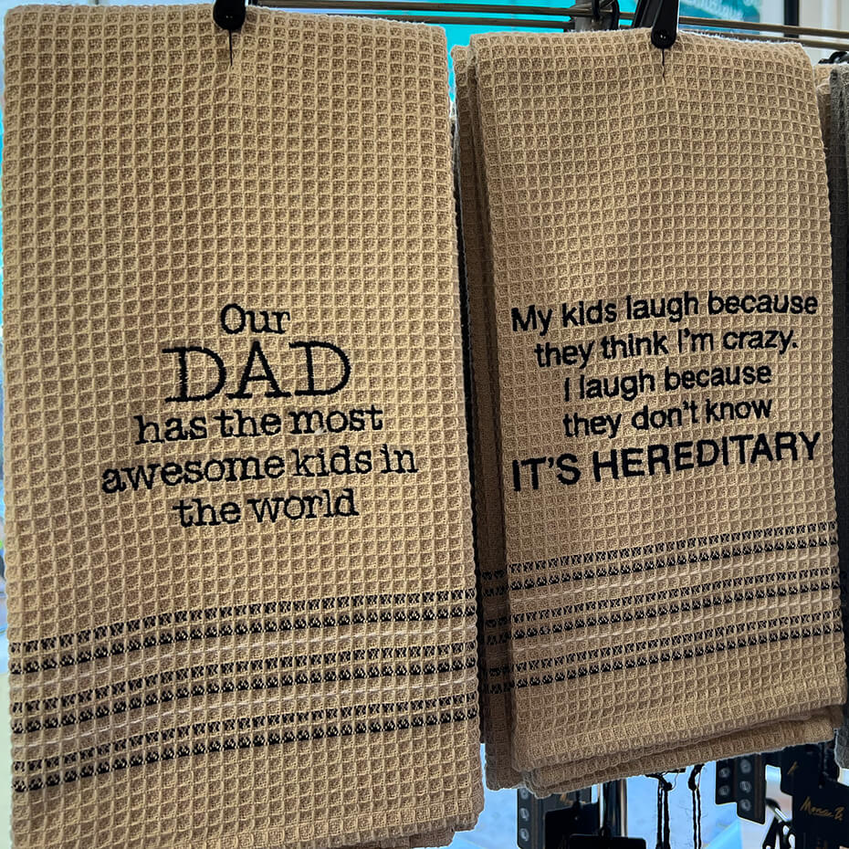 Two Mona B. hand towels on display at Magda and Malena's Boutique.