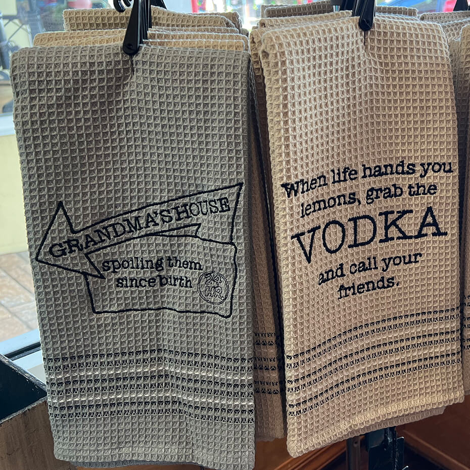 Two Mona B. hand towels on display at Magda and Malena's Boutique.