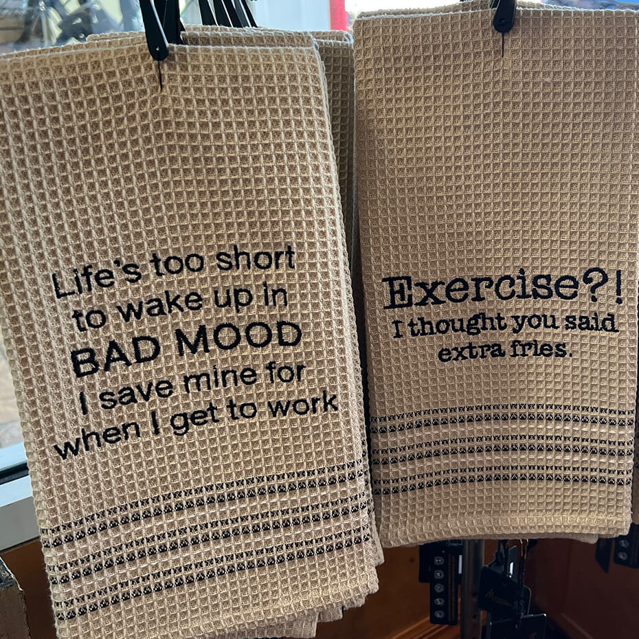 Two Mona B. hand towels on display at Magda and Malena's Boutique.