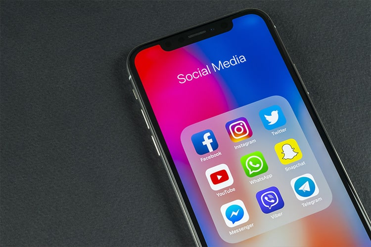 iPhone with social media icons in a folder