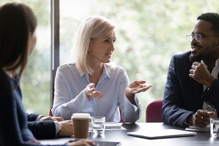 Executive speaking to her team in a board room
