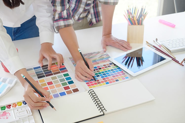 Two designers choosing colors for a brand