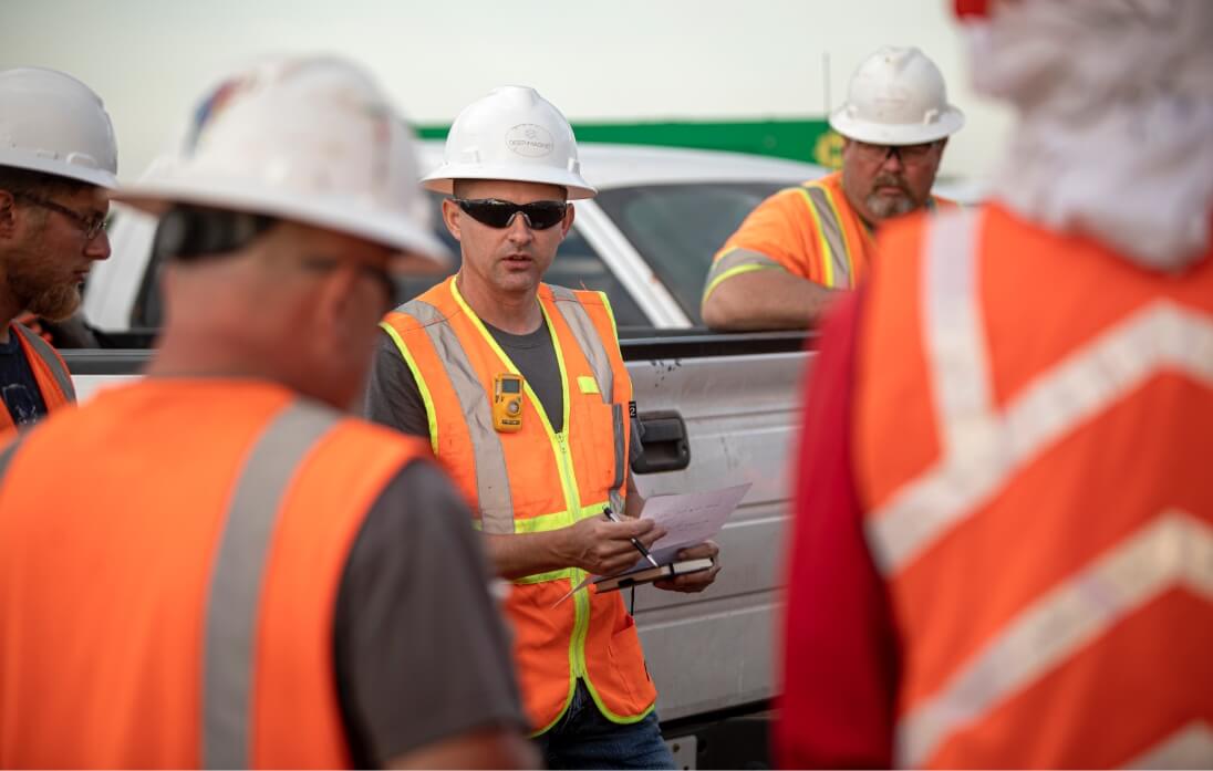 People in construction uniforms standing and talking