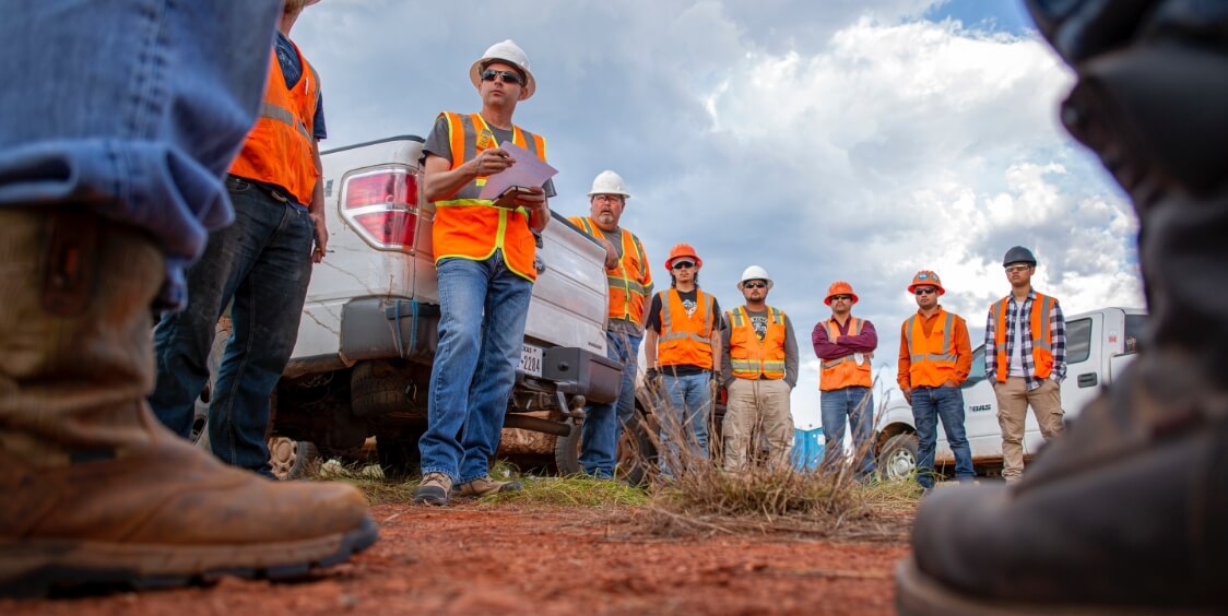 People in construction uniforms standing and talking