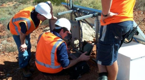 People working on equipment in field