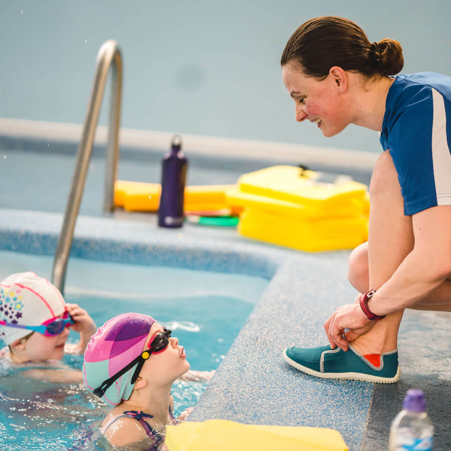 Swimming teacher teaching a young Student