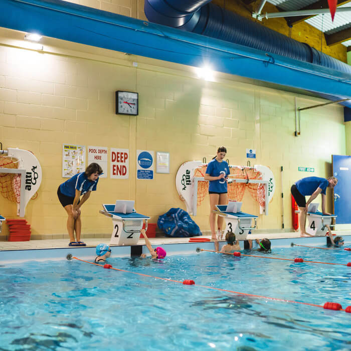 Swimming teacher teaching a young Student