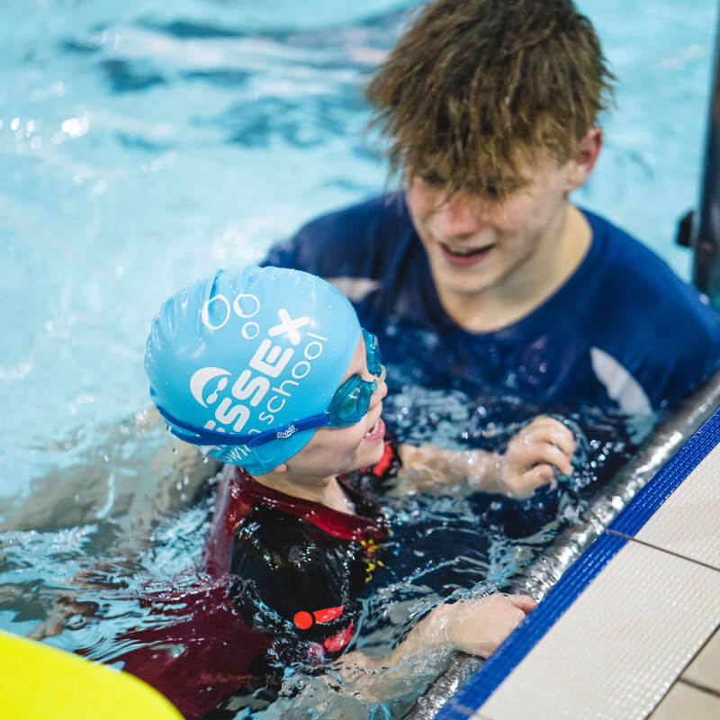 Swimming teacher teaching a young Student