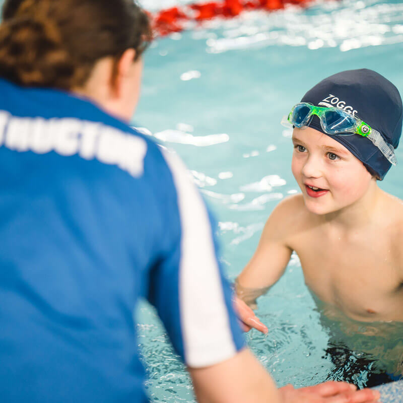Swimming teacher teaching a young Student