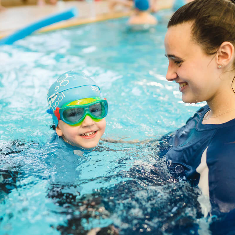 Swimming teacher teaching a young Student