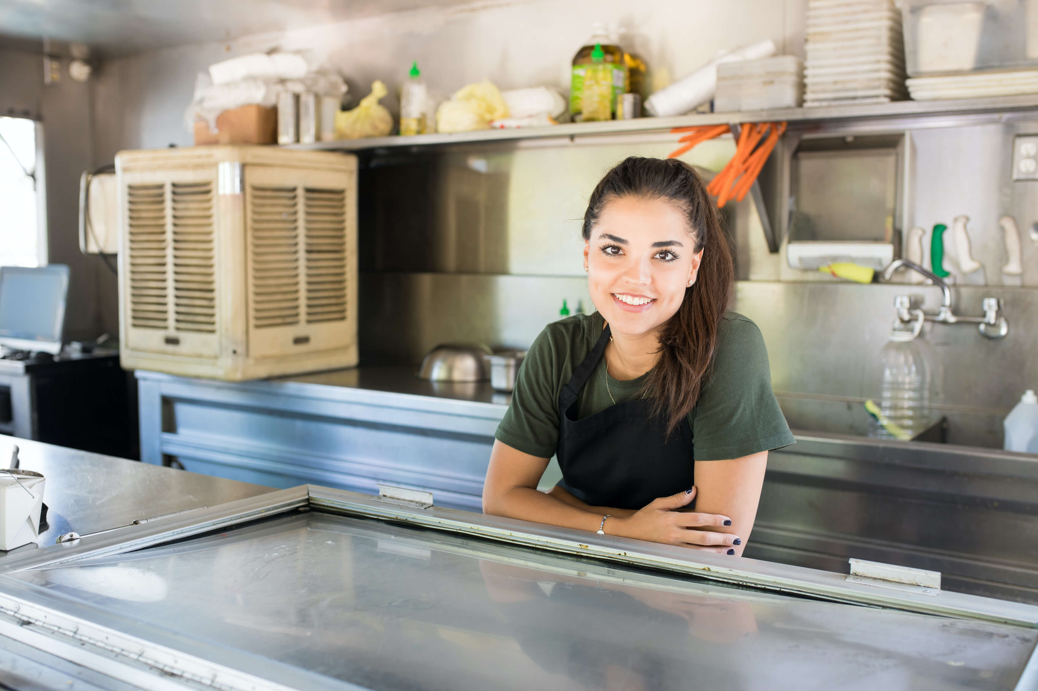 Young food truck owner in truck