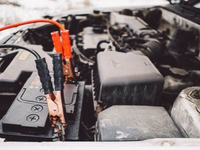jumper cables connected to a car battery