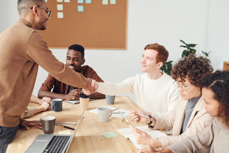 Man shaking hands in team meeting