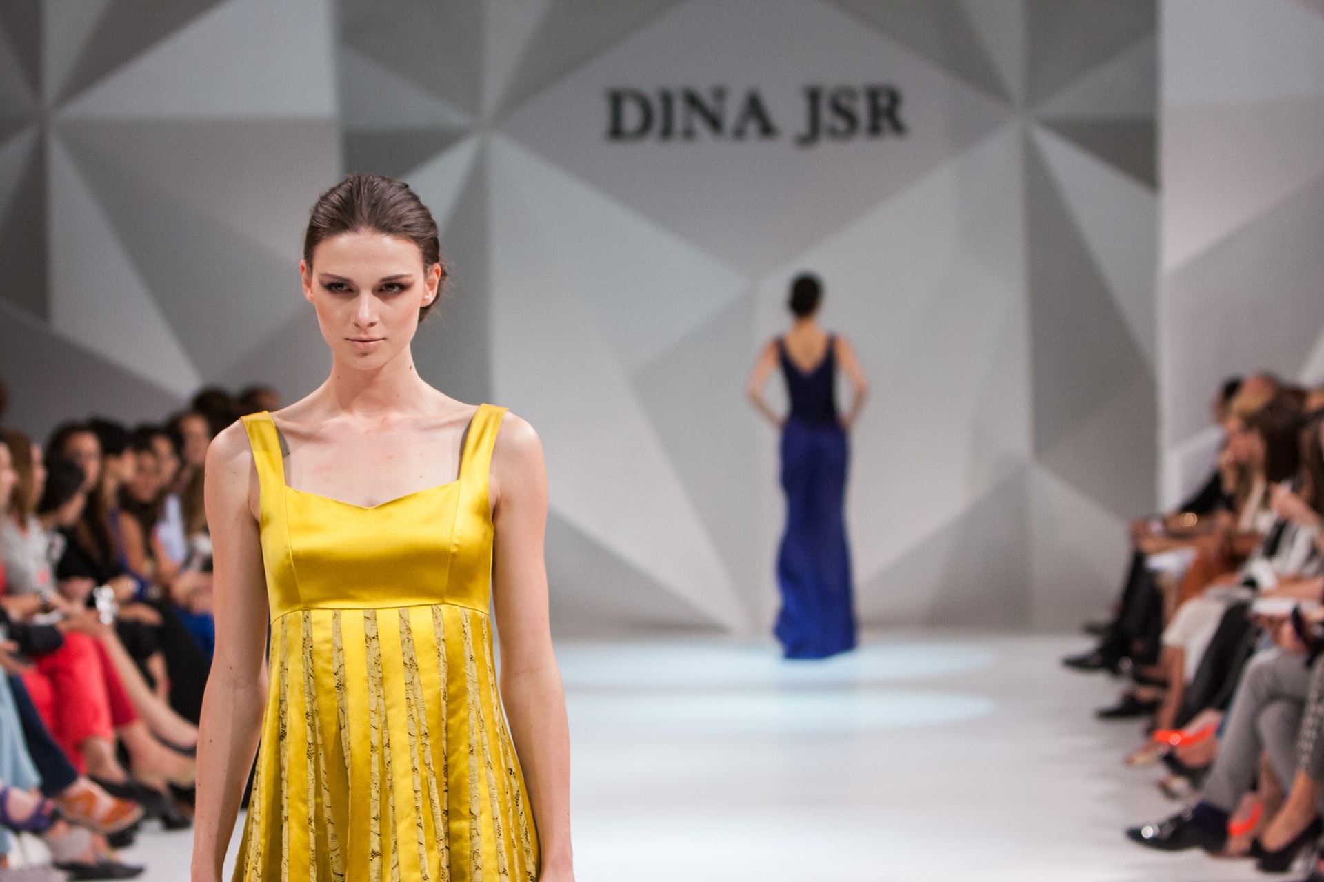 Lady in a yellow dress on a cat walk
