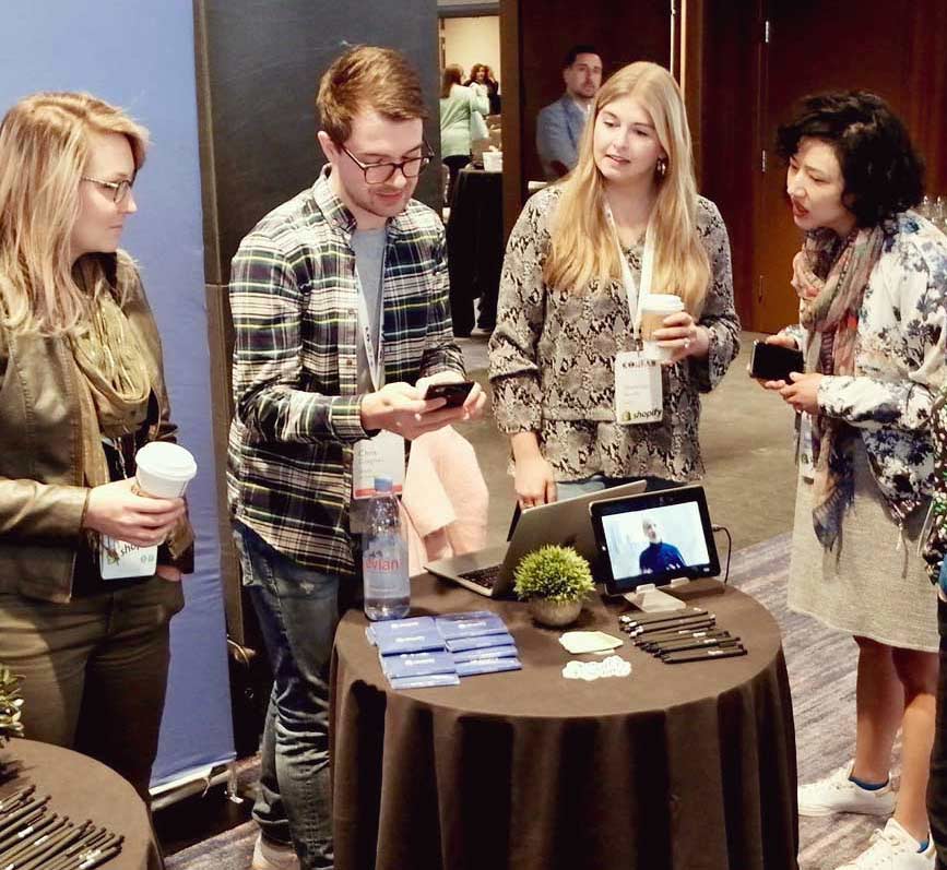Photo of attendees at a sponsor booth