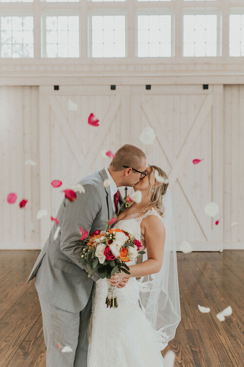 BrideAndGroomKissing-FallingPetals-Bouquet-BradNguyenPhotography.jpg