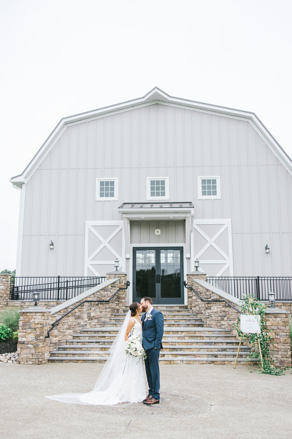 BrideAndGroomKissing-RusticBarn-CeremonyBuildingRosewoodFarms-ErikaLynnPhotography.jpg