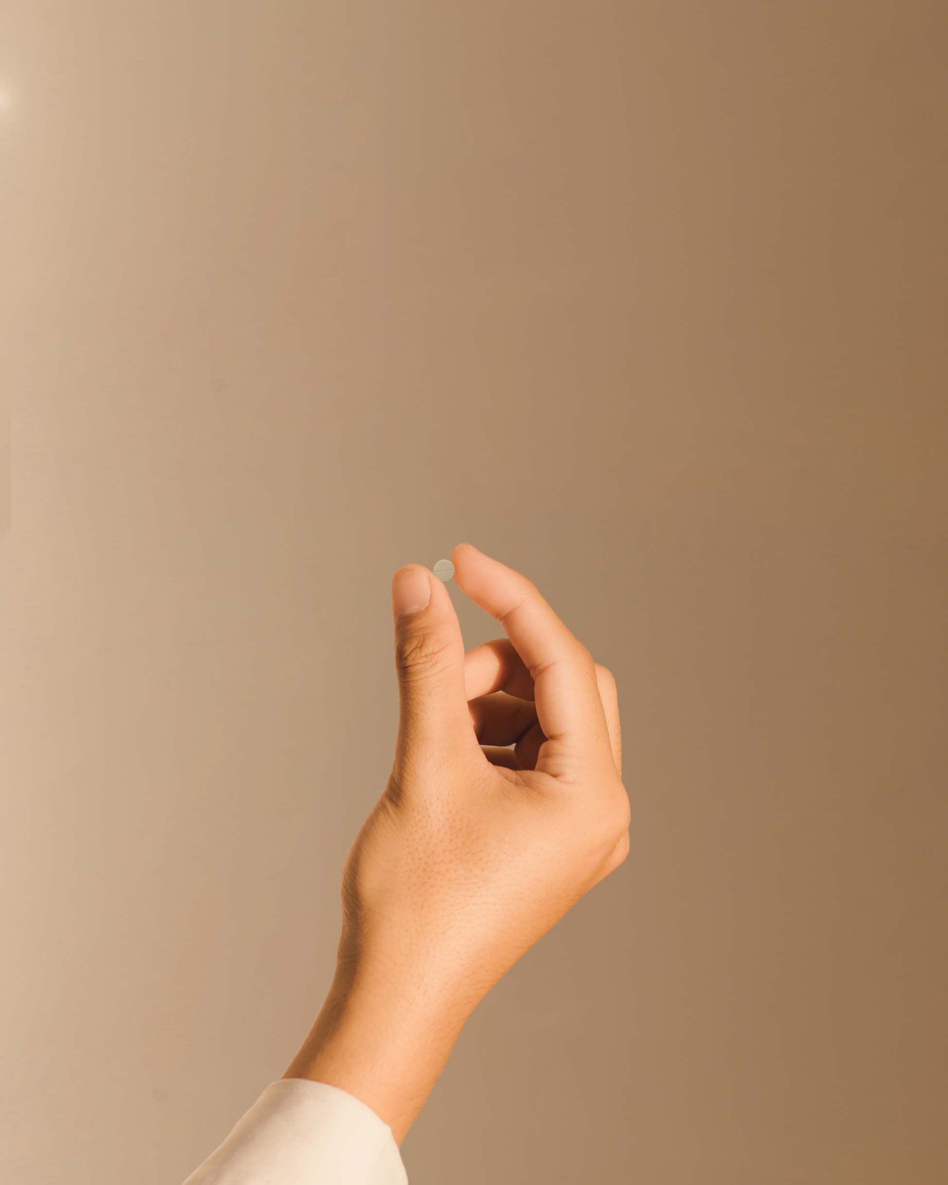 An image of a woman holding an eons dissolvable tablet.