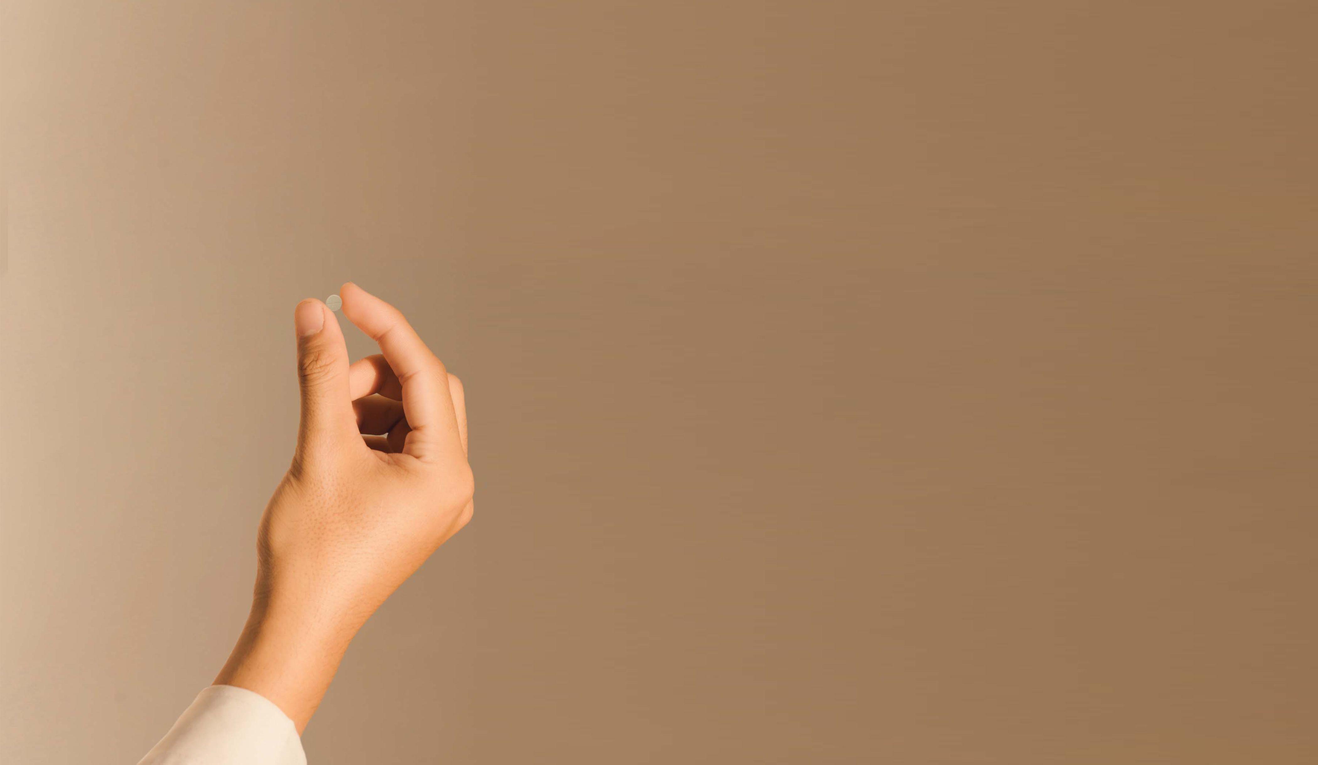 An Image of a girl holding an Eons dissolvable tablet