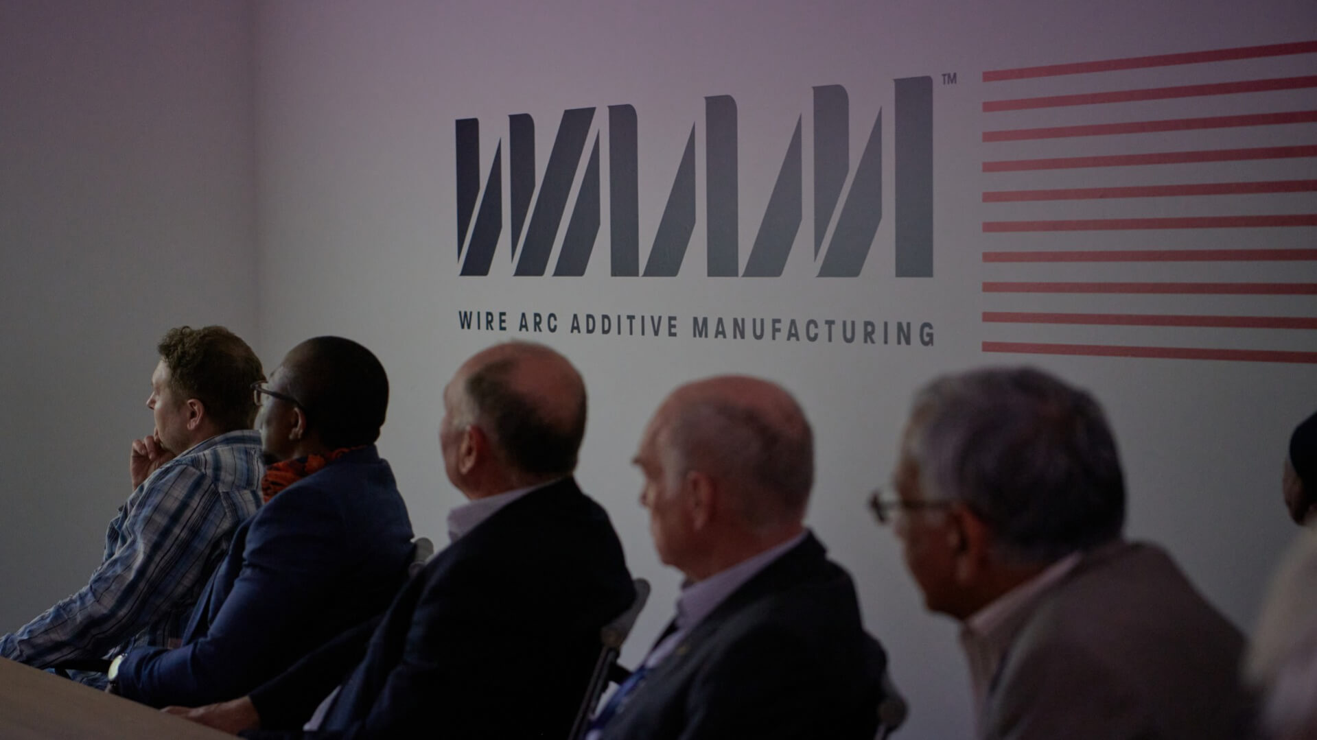 Inside WAAM3D Headquarters with people sitting at table