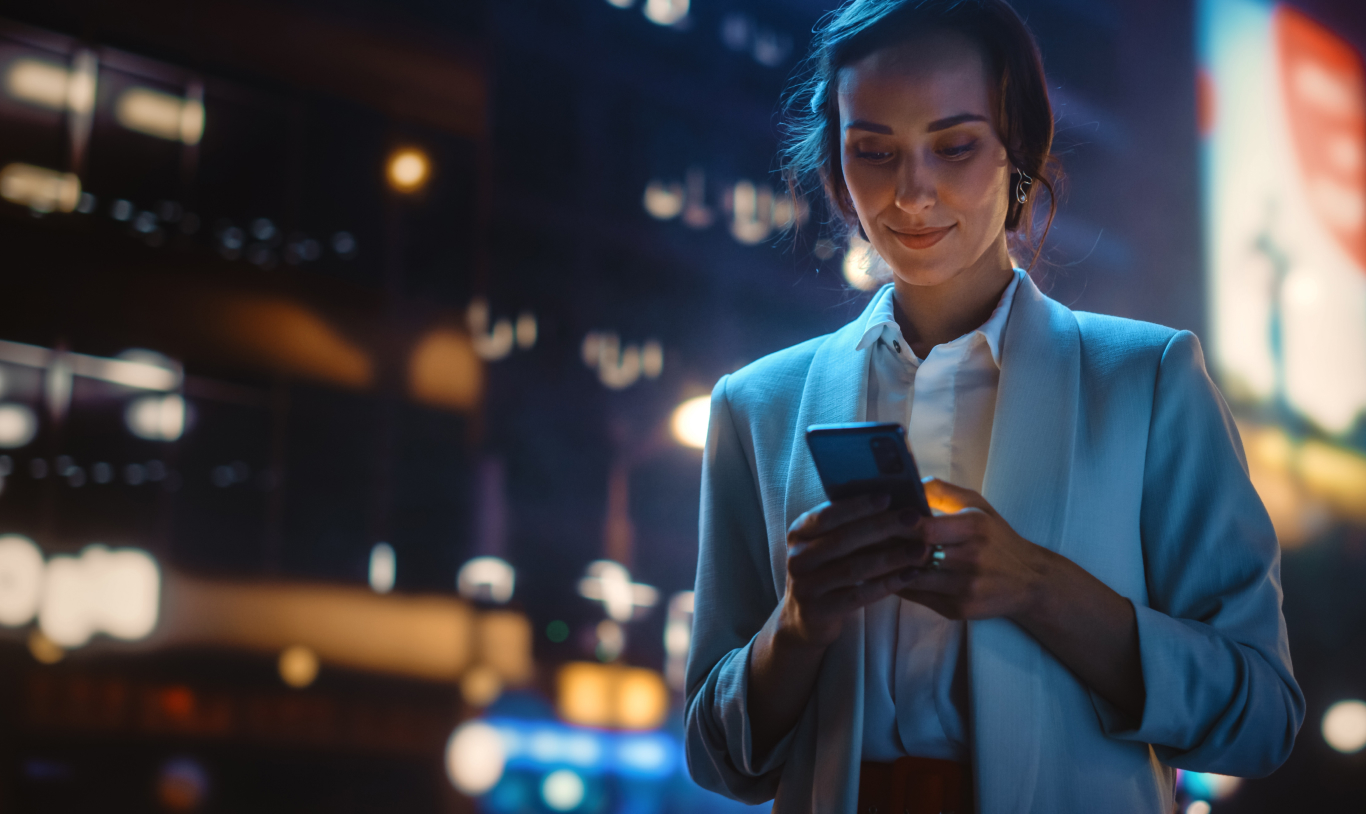 A woman using the Passfolio application on her phone to trade stocks and cryptocurrencies.