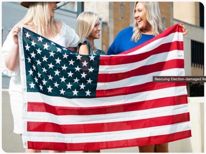 Women holding up an American flag.