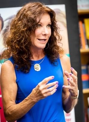 Heather Dugan giving giving a speech to an audience.