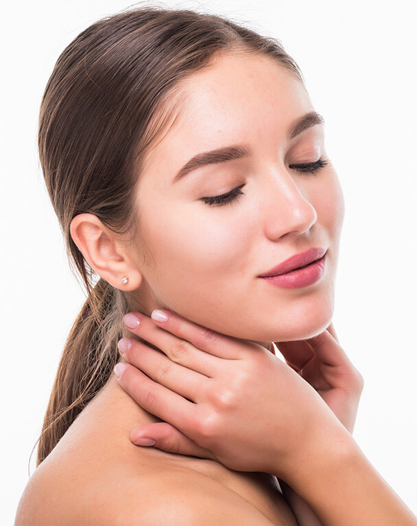 Woman with her eyes closed showing her glowing skin
