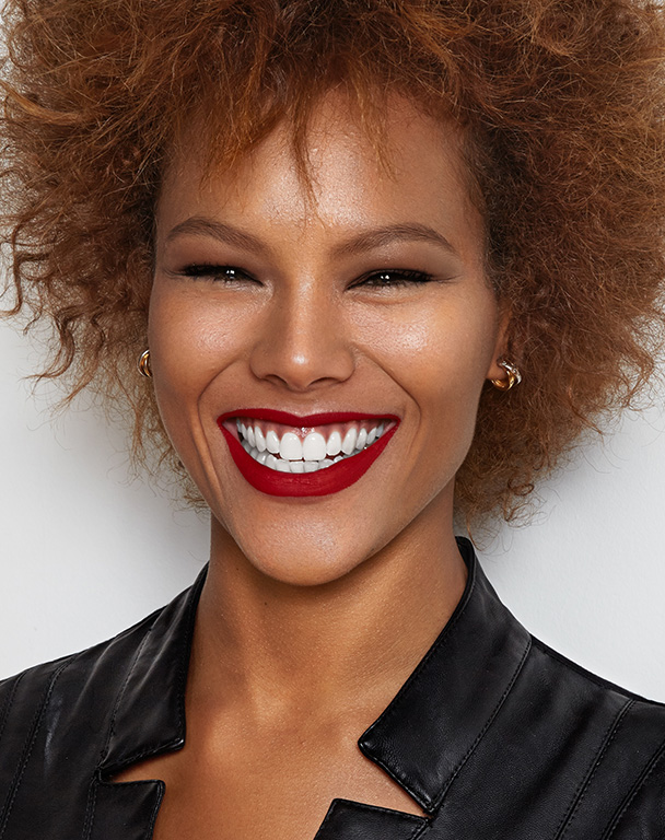 Dark skin woman with red lipstick and a big smile for InMode