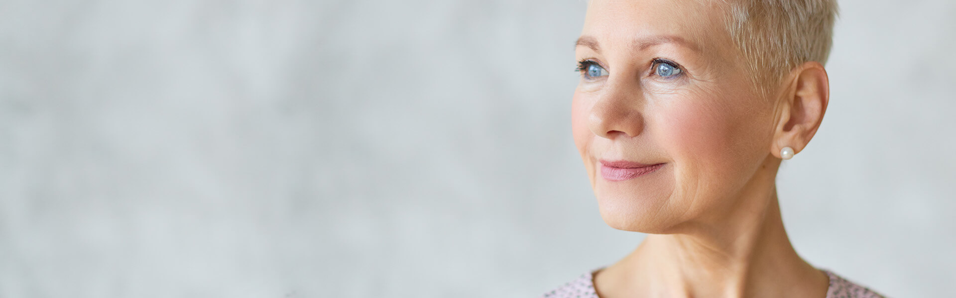 Mature woman with blue ayes and short hair with beautiful skin