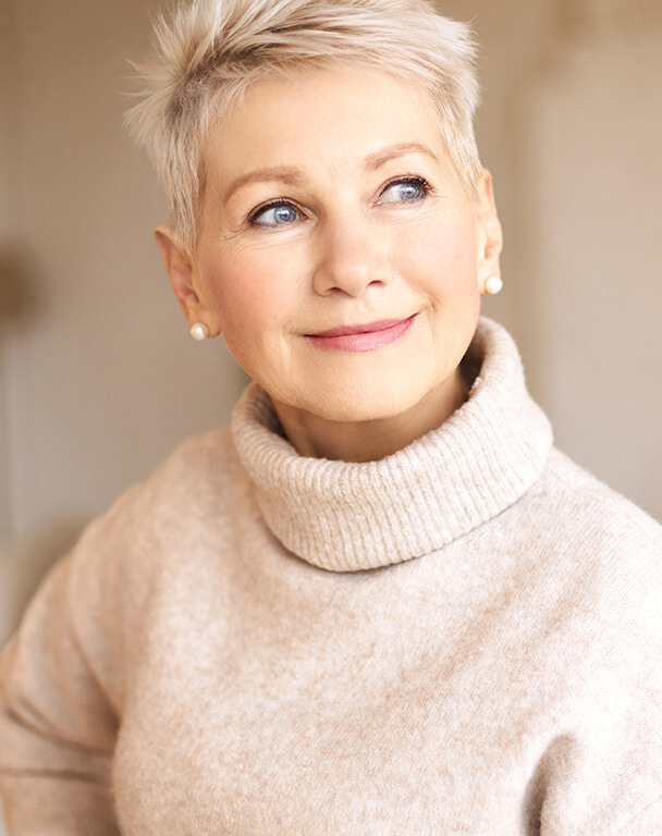 Mature woman smiling with healthy skin for Sculptra