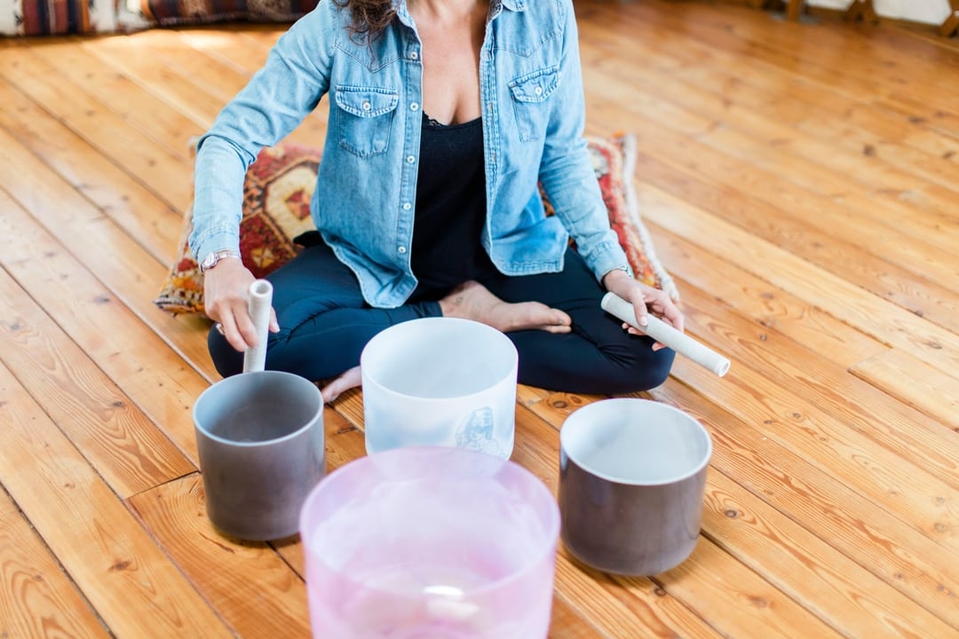 Woman hits singing bowls