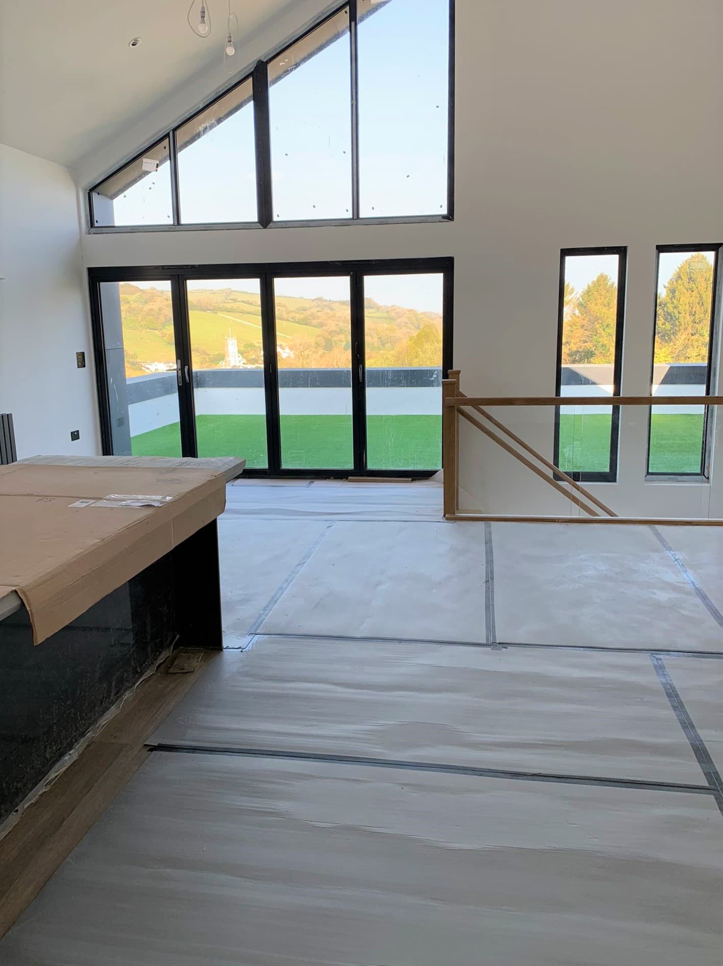 new build house builders cleaning with kitchen covered to protect it from cleaning