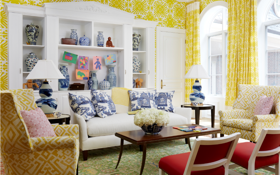 This show house room is unified by the color yellow used on walls, draperies, and furniture.